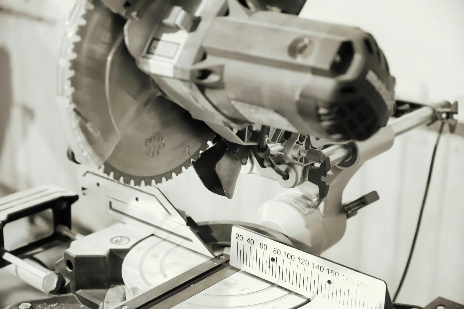 Close-up of a professional chop saw with measurement scale, ideal for woodworking tasks.